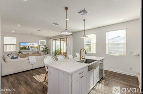 A modern kitchen with white cabinets and a large island.