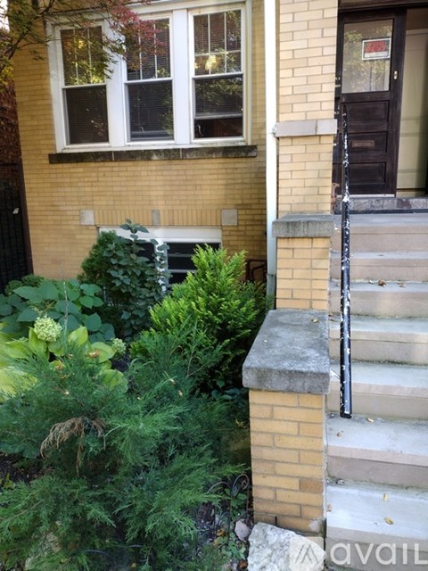 A house with a brown door and a window with white frames.