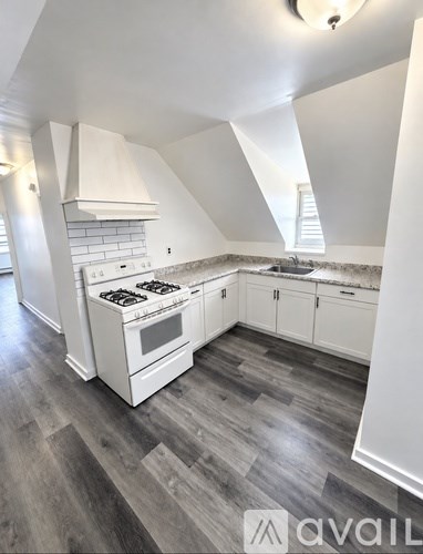 A kitchen with white appliances and cabinets.