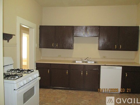 A kitchen with brown cabinets and a white stove.