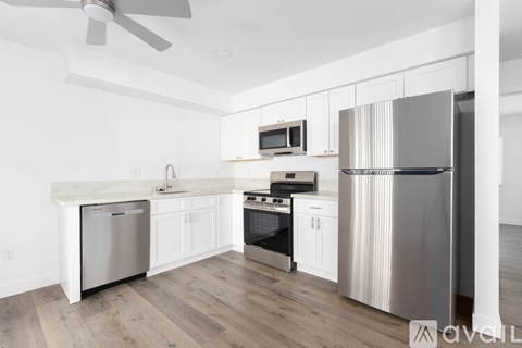A modern kitchen with stainless steel appliances and white cabinets.