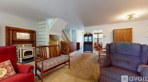A living room with a red couch and a grey couch.