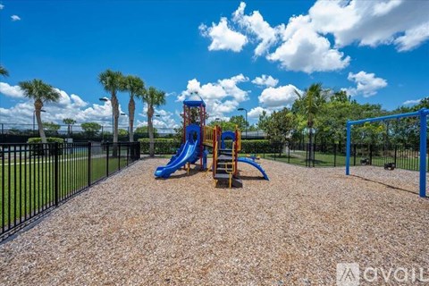 A playground with a blue slide and a yellow climbing frame.