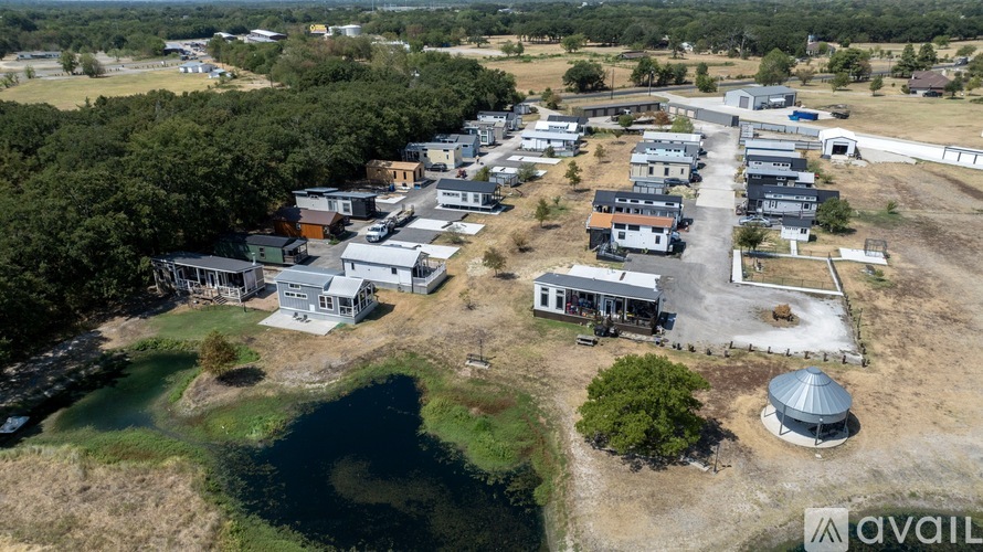 A bird's eye view of a residential area with houses and a water body.