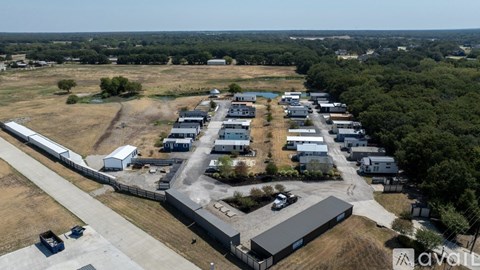 An aerial view of a large industrial area with multiple buildings and vehicles.