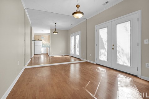 A room with wooden floors and white walls.