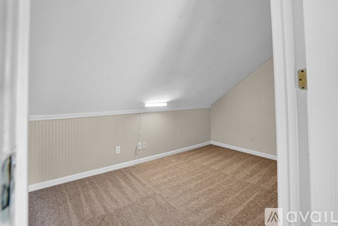 A room with a carpeted floor and a white ceiling.
