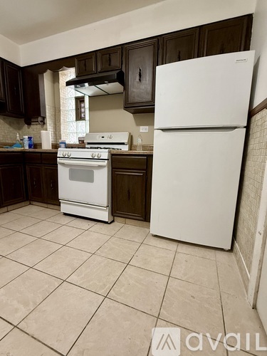 A kitchen with a white fridge and stove.