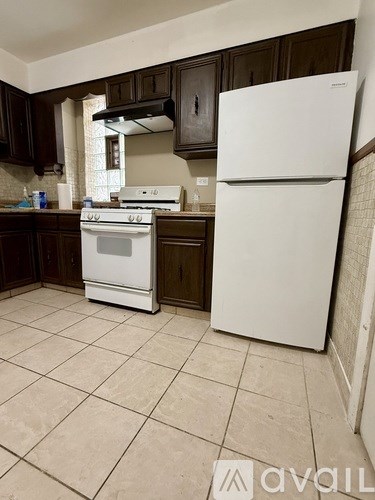 A kitchen with a white fridge and stove.