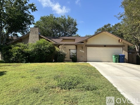 A house with a garage and a driveway in front.