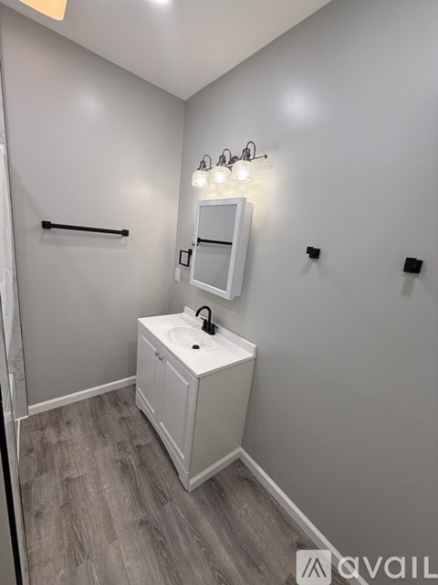 A bathroom with a sink and a mirror.