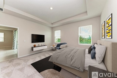 A bedroom with a large bed and a television on the wall.
