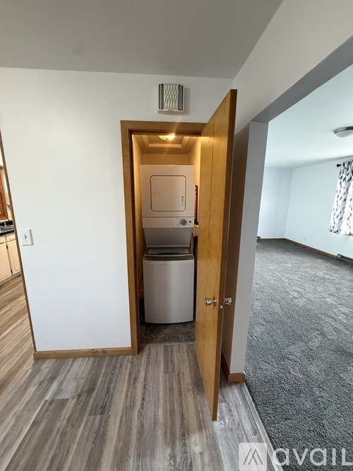 A small kitchen with a dishwasher and a refrigerator.