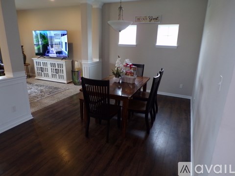 A dining room with a wooden table and chairs.