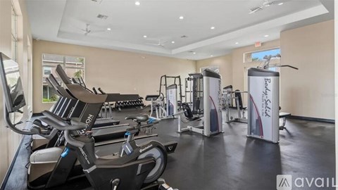 A gym with treadmills, elliptical machines, and other exercise equipment.