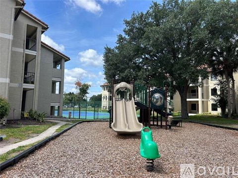 A playground with a green slide and a green toy car.