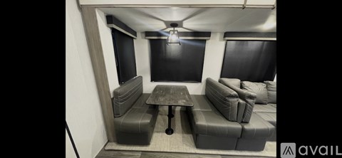 A living room with grey couches and a wooden table.