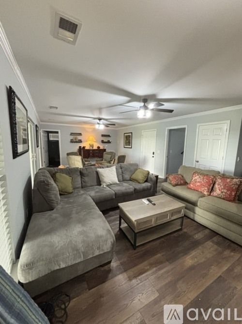 A living room with a grey couch and a coffee table.