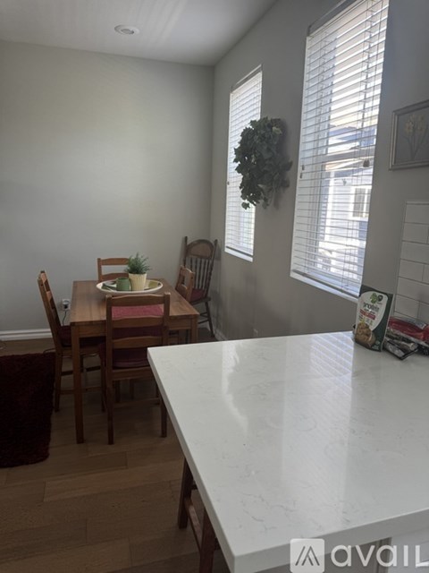 A dining room with a table and chairs.
