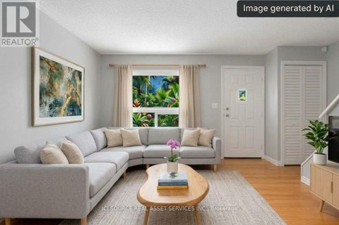 A living room with a grey sofa, a coffee table, and a painting on the wall.