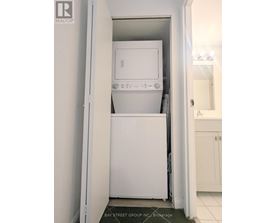 A white dishwasher and microwave in a small kitchen.