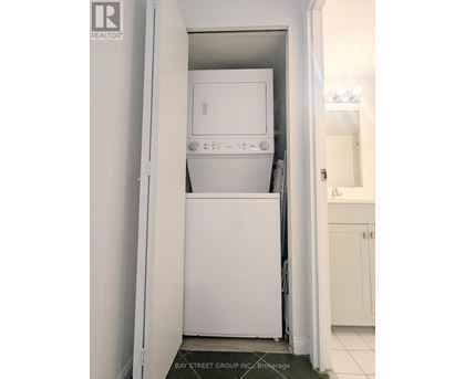 A white dishwasher and microwave in a small kitchen.