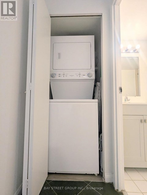 A white dishwasher and microwave in a small kitchen.