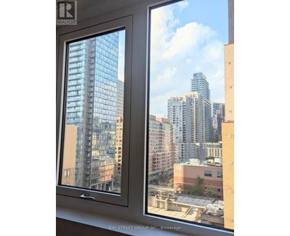 A window with a view of a city skyline.