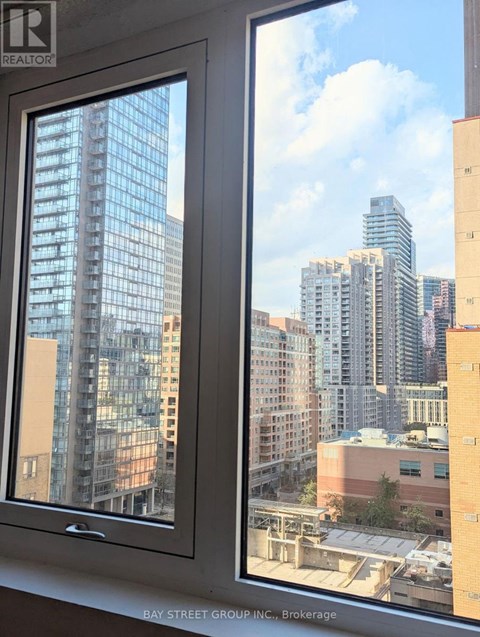 A window with a view of a city skyline.