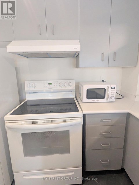 A white oven and microwave in a kitchen.