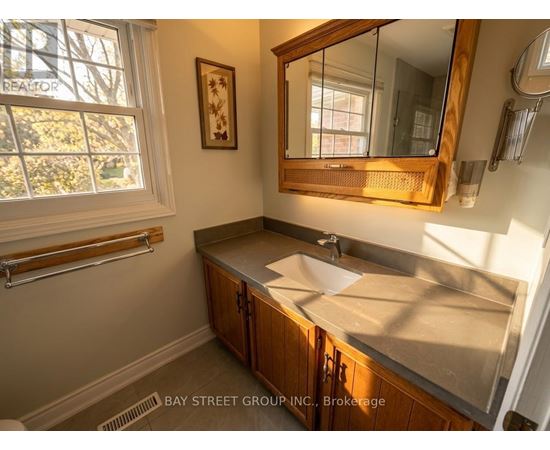 A bathroom with a sink and a mirror.