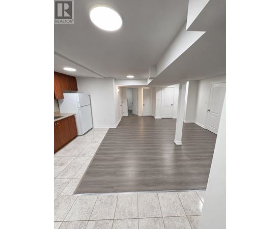 A large open room with a kitchen area and a hallway.