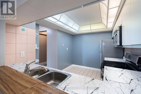 A kitchen with a sink and a counter top.