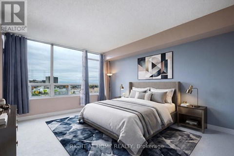A bedroom with a large bed and a view of the ocean.