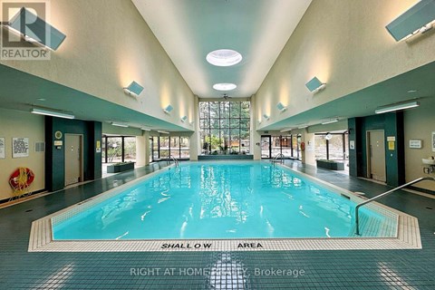 A large indoor swimming pool with a shallow area.