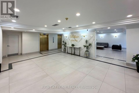 A spacious office lobby with a reception desk and comfortable seating area.
