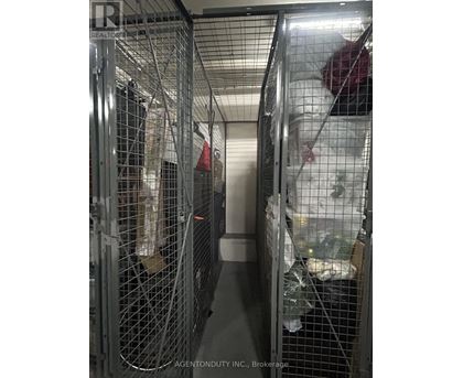 A long metal cage with a person inside.