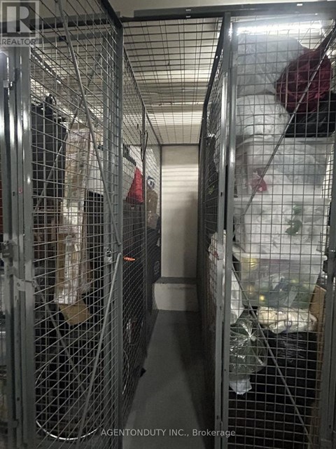 A long metal cage with a person inside.