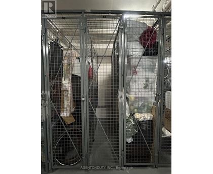 A metal cage with a white plastic bag hanging from it.