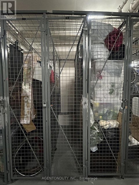 A metal cage with a white plastic bag hanging from it.