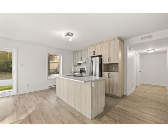 A kitchen with wooden cabinets and a refrigerator.