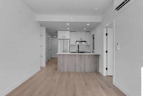 A kitchen with white cabinets and a wooden island.