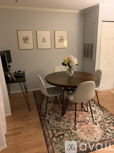 A dining room with a round table and chairs.