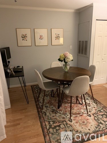 A dining room with a round table and chairs.