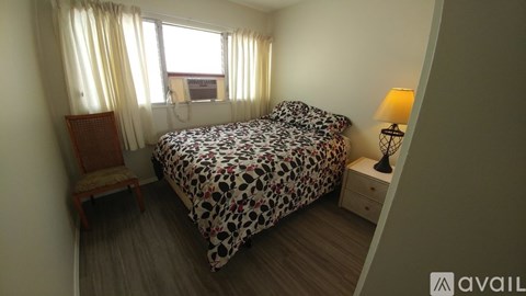 A bedroom with a leopard print bedspread and a wooden chair.