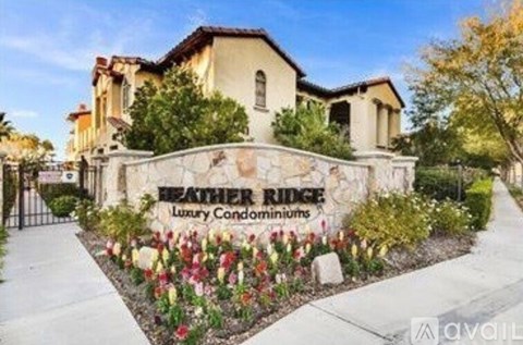The front of a building with the name Feather Ridge Luxury Condominiums on it.