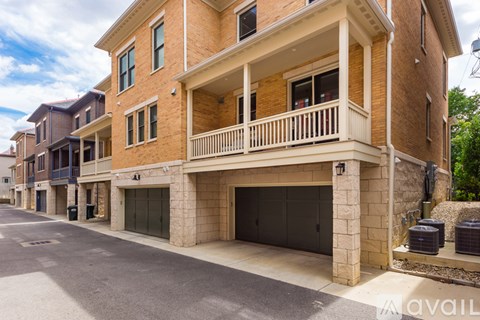 A two-story building with a balcony and garage.