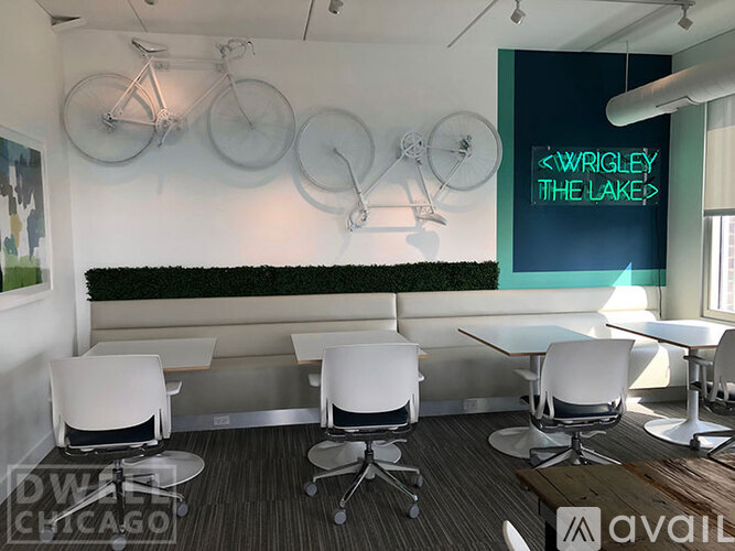 A conference room with a green wall and a sign that says "Wrigley The Lakes".