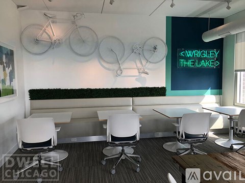 A conference room with a green wall and a sign that says "Wrigley The Lakes".