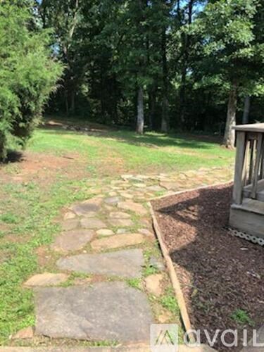 A stone pathway leads through a grassy area.
